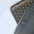 Two black rubber mats with textured surface on a white background