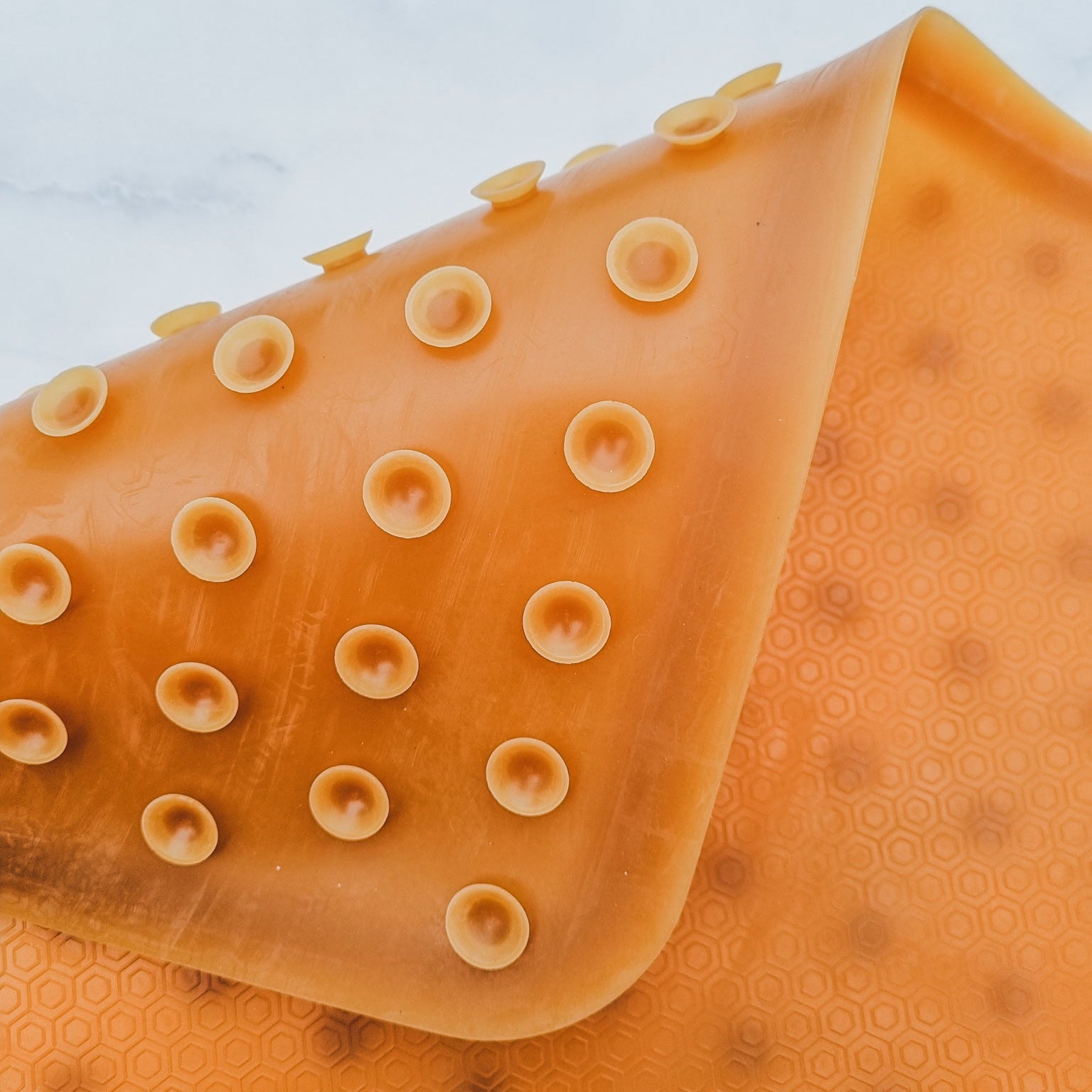 Close-up of an orange textured object with a light blue background