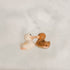 Two rubber ducks kissing on a white background