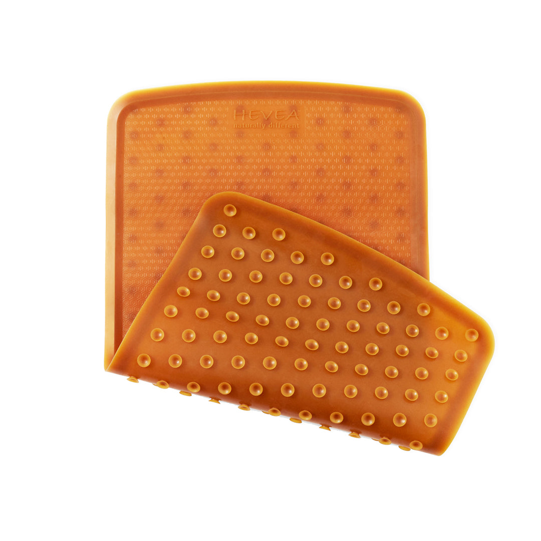 Hevea natural rubber anti slip baby bath mat with honeycomb design and suction cups for safety.