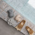 Pair of natural rubber fins on a stone surface near a pool