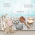 Eco-friendly sand toys and accessories on a stone surface with a beach-themed background.