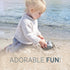Child playing in the sand with text 'ADORABLE FUN!' at the beach